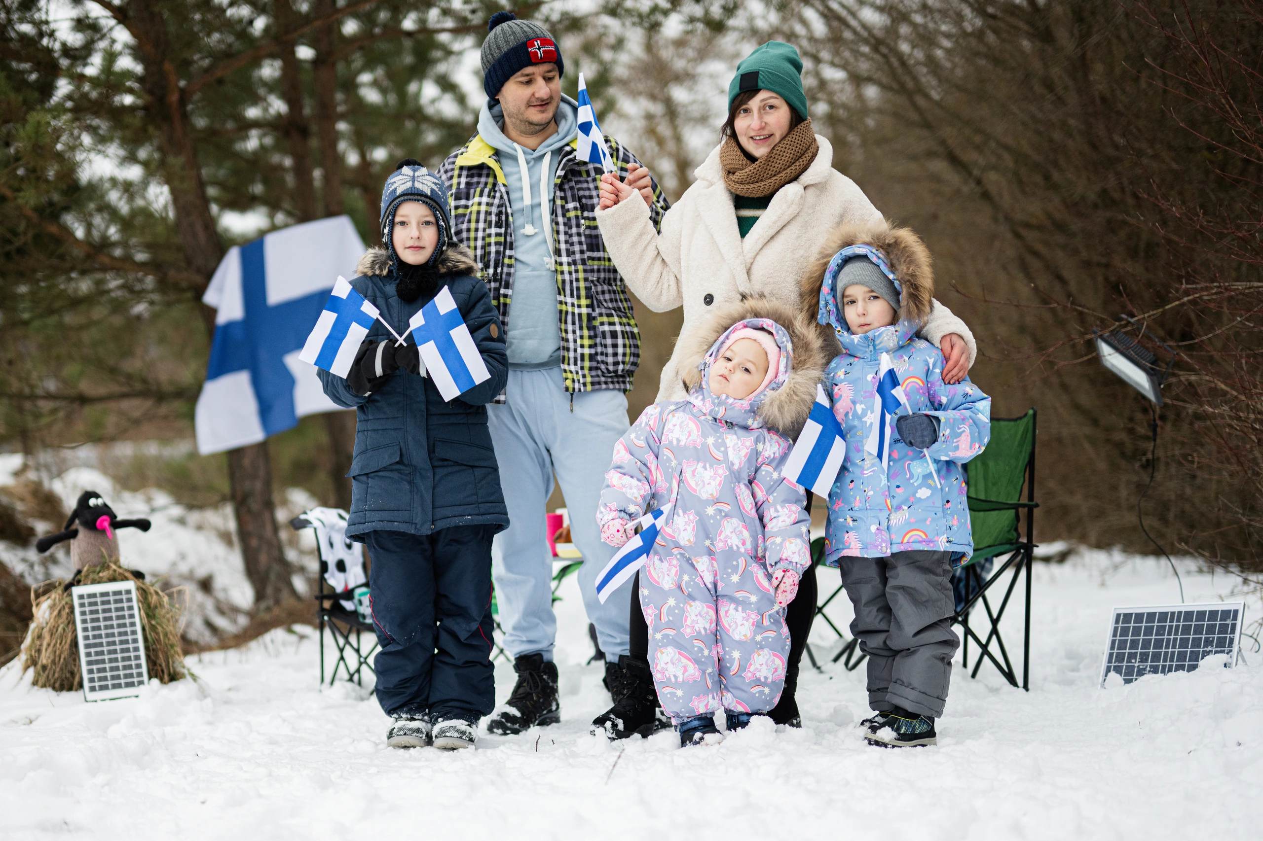 Familj med finska flaggor i vinterlandskap, Finland